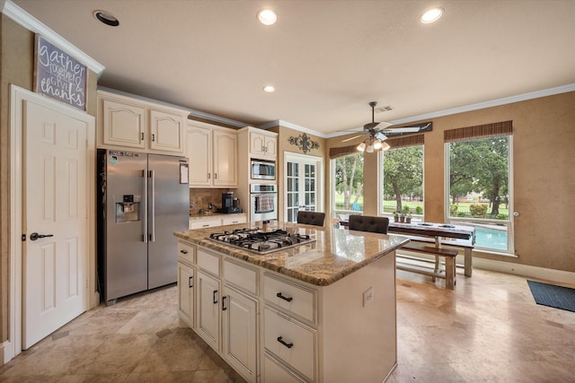 kitchen with crown molding, stainless steel appliances, recessed lighting, a kitchen island, and light stone countertops