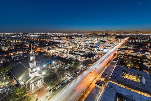 aerial view at night featuring a view of city lights