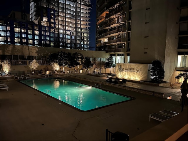 community pool featuring a view of city and a patio