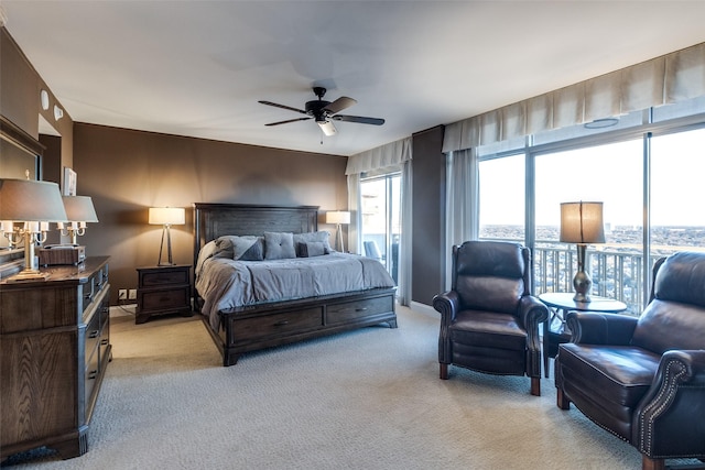 bedroom featuring light colored carpet, baseboards, and ceiling fan