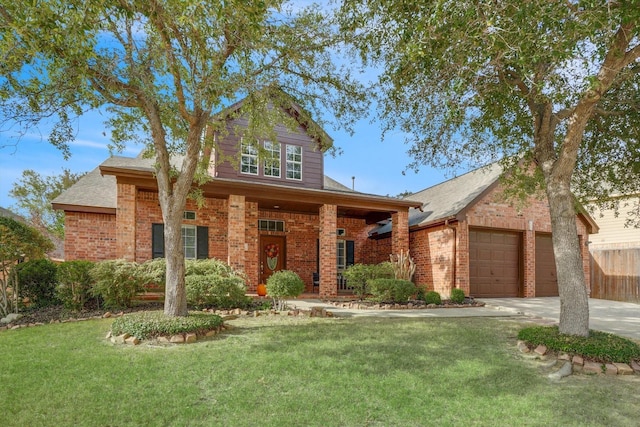 traditional-style house with an attached garage, a front yard, concrete driveway, and brick siding