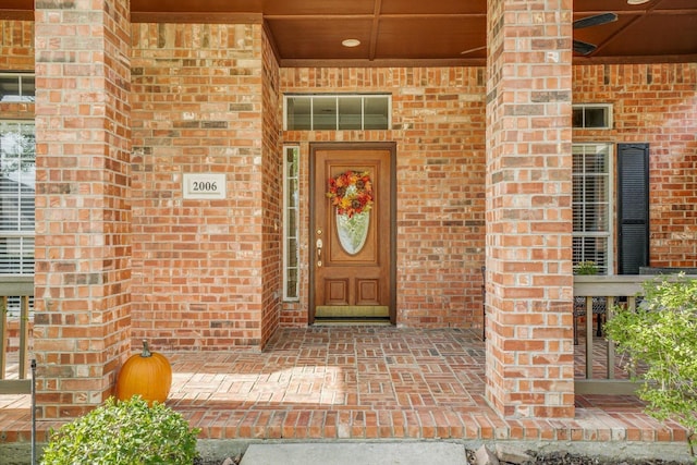 entrance to property featuring brick siding