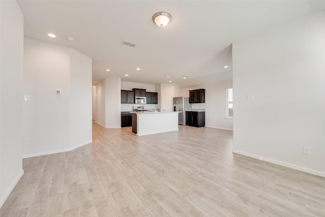 unfurnished living room featuring baseboards, recessed lighting, visible vents, and light wood-type flooring