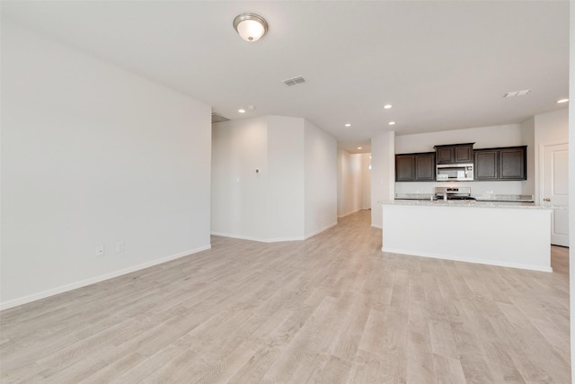 unfurnished living room featuring recessed lighting, visible vents, baseboards, and light wood-style floors