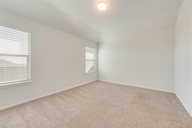 empty room with baseboards and light colored carpet