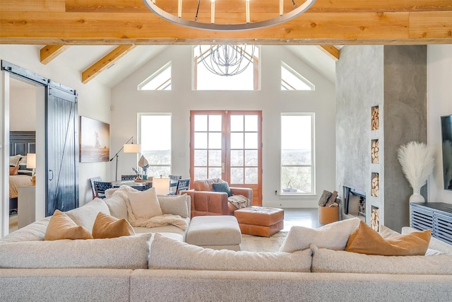 living area with a barn door, high vaulted ceiling, beamed ceiling, and a fireplace