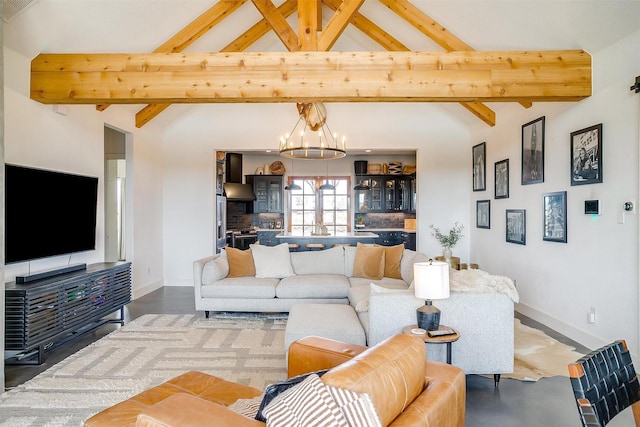 living room with lofted ceiling with beams, baseboards, and a notable chandelier