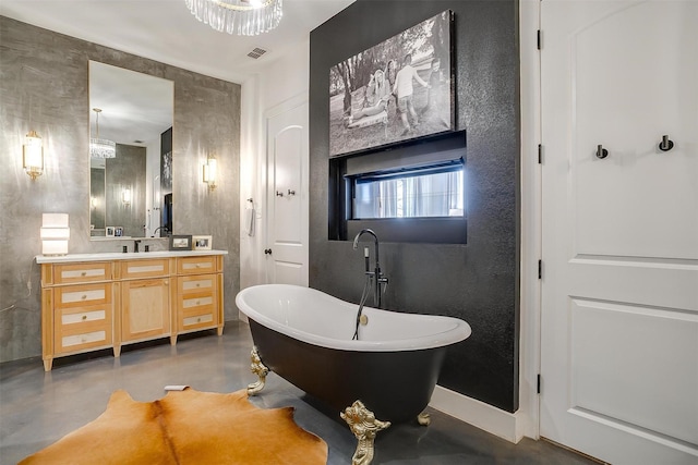 full bathroom featuring a freestanding tub, visible vents, finished concrete flooring, baseboards, and vanity