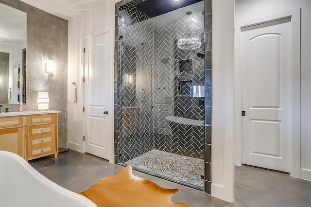 bathroom featuring vanity, tiled shower, and concrete floors