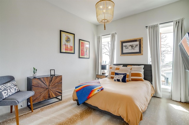 bedroom with baseboards and a notable chandelier