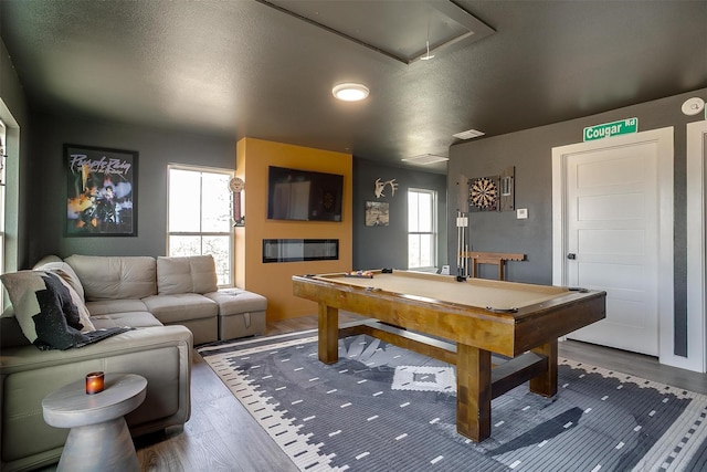 game room featuring plenty of natural light, attic access, wood finished floors, and pool table