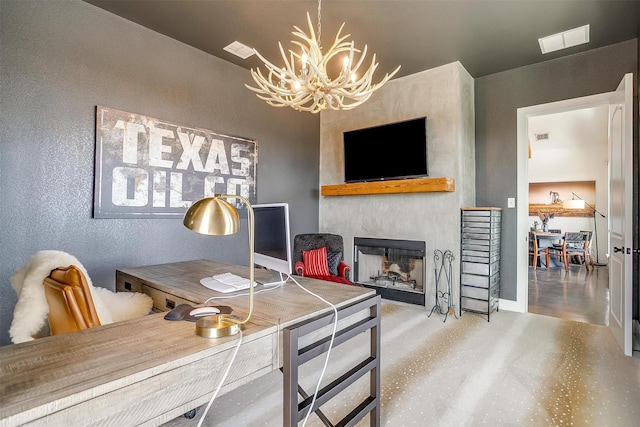 office featuring visible vents, a chandelier, a fireplace, and a textured wall