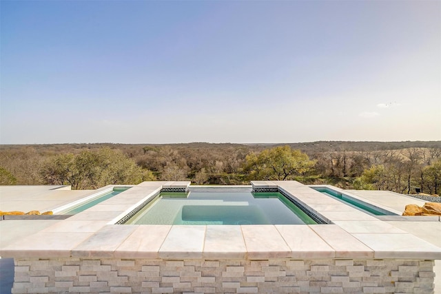 view of swimming pool featuring an in ground hot tub