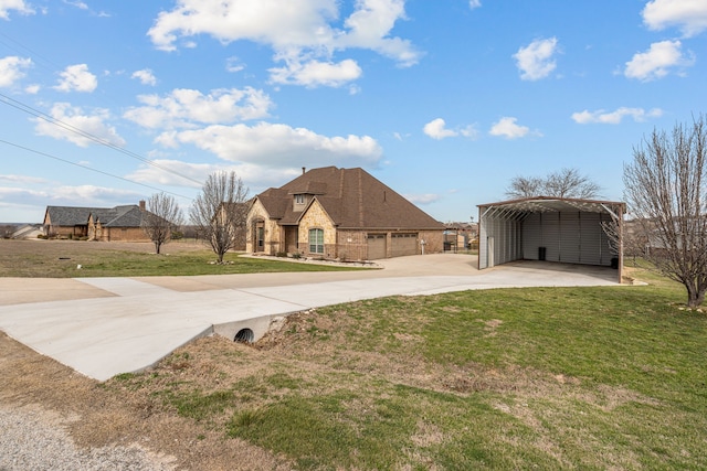 view of yard with a carport and concrete driveway