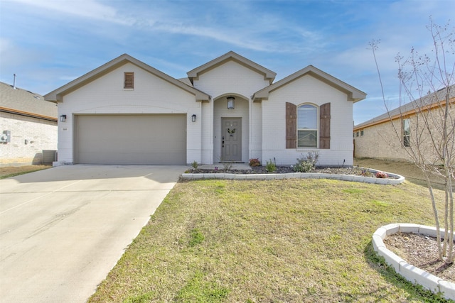 single story home featuring a garage, driveway, brick siding, and a front yard