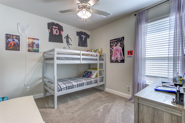 carpeted bedroom with ceiling fan and baseboards