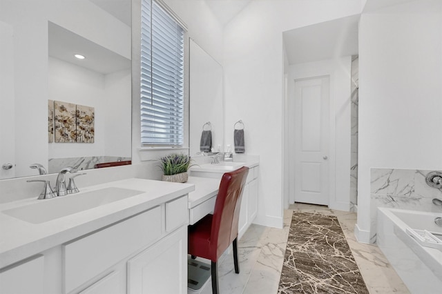 full bath featuring marble finish floor, baseboards, a bath, and vanity