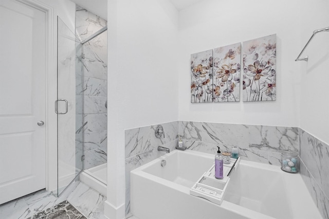 bathroom with marble finish floor, a shower stall, and a bath