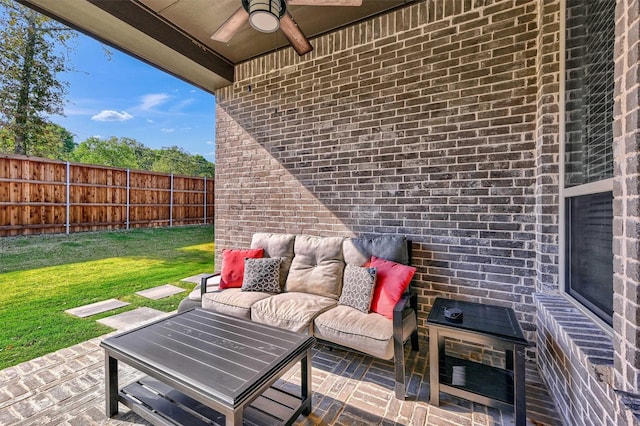 view of patio with a ceiling fan, fence, and an outdoor living space