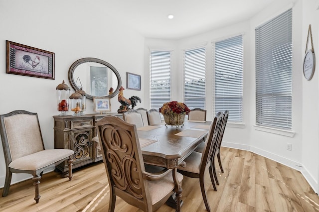 dining space with recessed lighting, light wood-style flooring, and baseboards