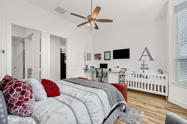 bedroom featuring baseboards, visible vents, lofted ceiling, ceiling fan, and wood finished floors