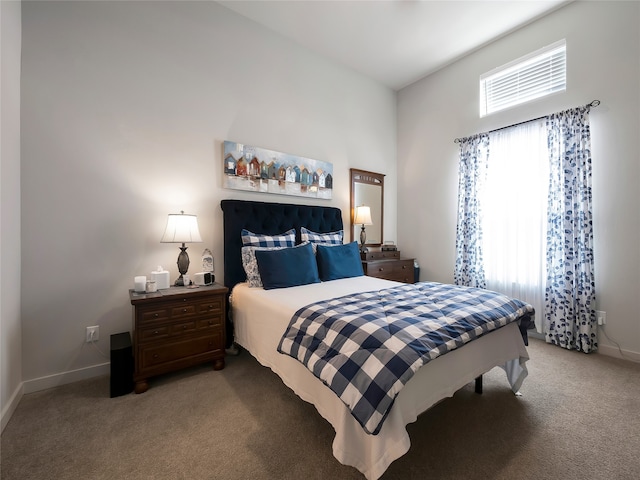 bedroom featuring light carpet and baseboards