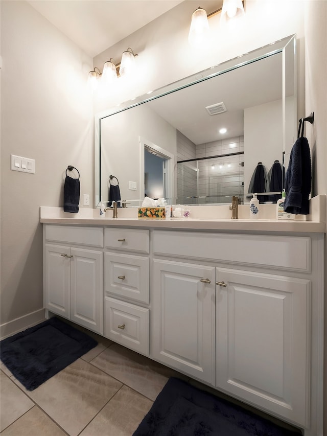 full bathroom featuring double vanity, a stall shower, visible vents, and tile patterned floors