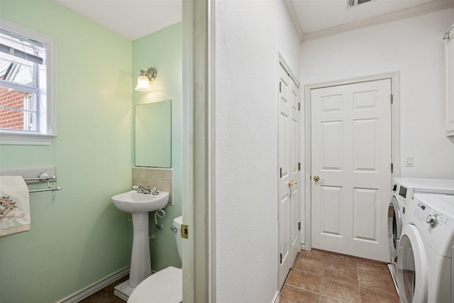 bathroom with visible vents, toilet, tile patterned flooring, crown molding, and washing machine and dryer