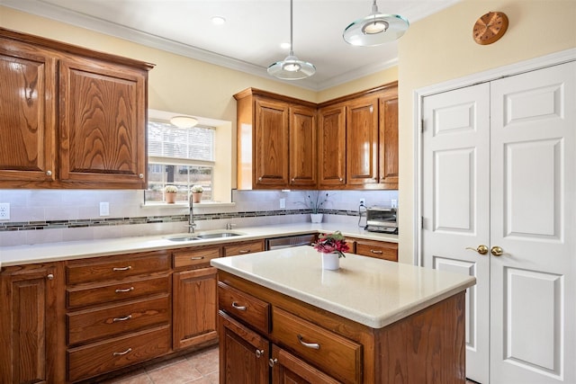 9705 Whitney Ct, Granbury, TX 76049 - kitchen with a sink, brown cabinetry, backsplash, and crown molding