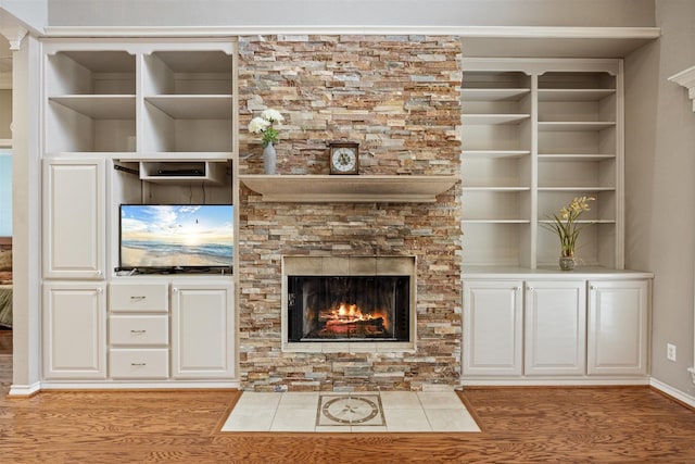 unfurnished living room featuring a fireplace and wood finished floors