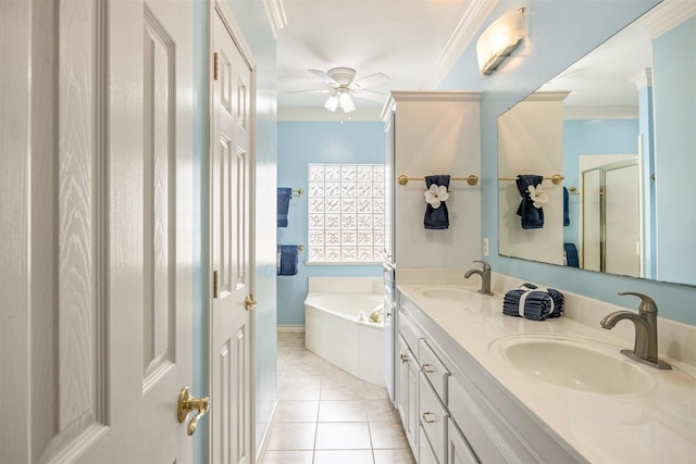 full bathroom featuring a garden tub, ornamental molding, tile patterned flooring, and a sink