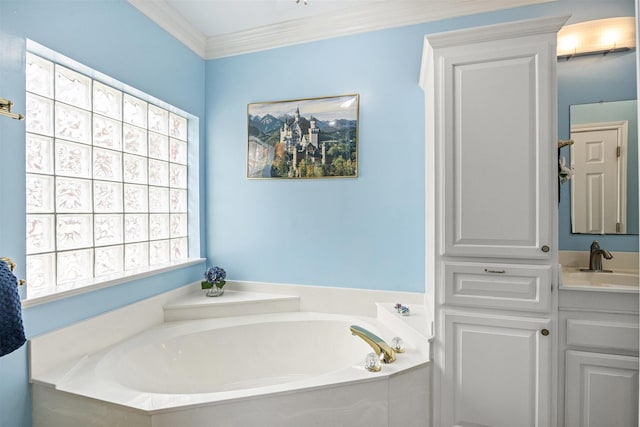 bathroom with ornamental molding, a garden tub, and vanity