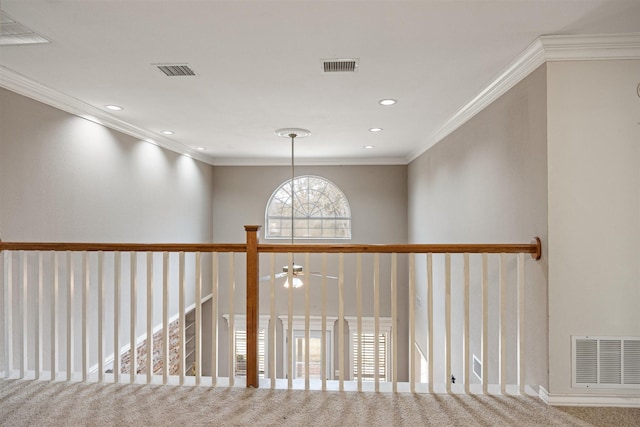 corridor with carpet floors, visible vents, and ornamental molding