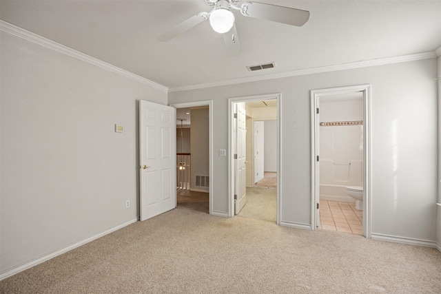 unfurnished bedroom featuring ornamental molding, carpet flooring, visible vents, and baseboards