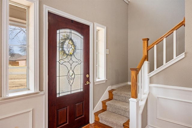 entrance foyer with stairway and baseboards