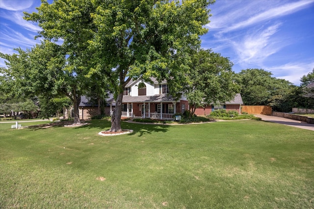 9705 Whitney Ct, Granbury, TX 76049 - view of front of property featuring a porch, a front yard, and brick siding