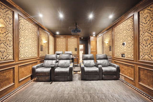 carpeted home theater room featuring ornamental molding, recessed lighting, and a decorative wall