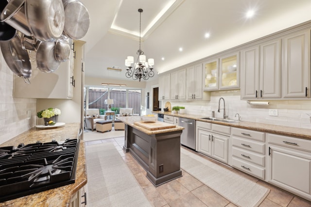 kitchen with pendant lighting, black gas cooktop, tasteful backsplash, a sink, and dishwasher