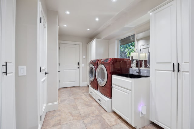 clothes washing area with cabinet space, recessed lighting, washer and clothes dryer, a sink, and light tile patterned flooring