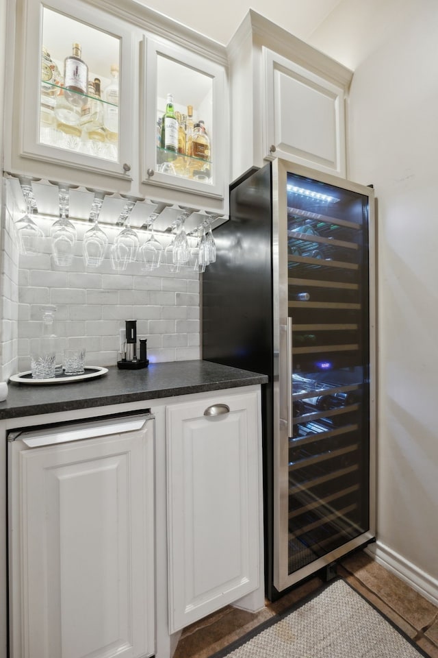 bar featuring a dry bar, wine cooler, and decorative backsplash