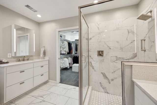 full bath featuring marble finish floor, vanity, a marble finish shower, and visible vents