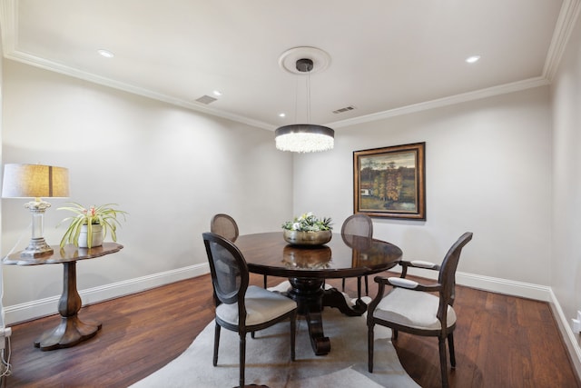 dining space with visible vents, baseboards, and wood finished floors