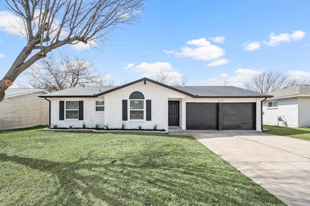 view of front facade with a front lawn, concrete driveway, brick siding, and an attached garage