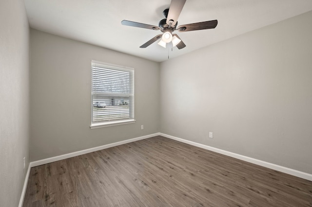 unfurnished room featuring ceiling fan, baseboards, and wood finished floors