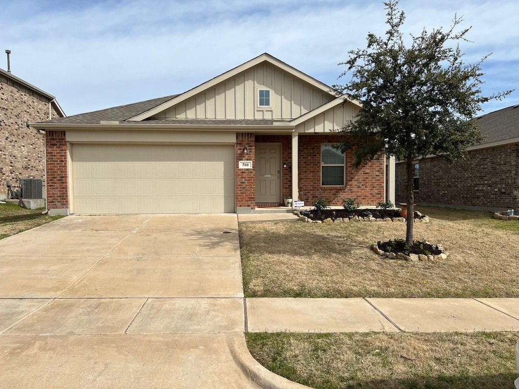 ranch-style home with driveway, central AC unit, an attached garage, board and batten siding, and brick siding