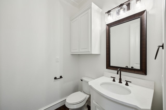 half bath featuring toilet, baseboards, and vanity