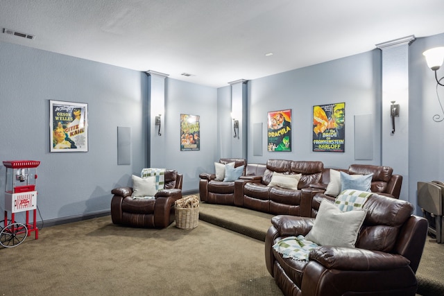 cinema with carpet, decorative columns, and visible vents