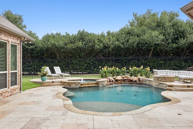 view of swimming pool featuring a pool with connected hot tub, a patio, and fence