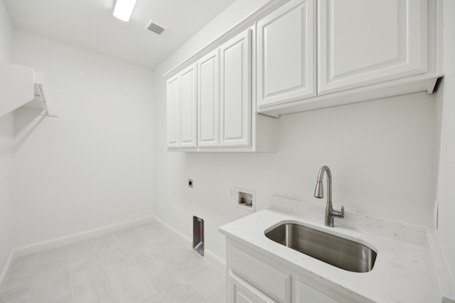 clothes washing area with hookup for a washing machine, a sink, baseboards, cabinet space, and electric dryer hookup