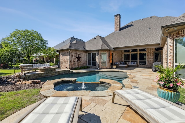 outdoor pool with an in ground hot tub, a patio, and outdoor lounge area